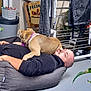 Dragone a rejoint le concours — aidez-le/la à gagner de superbes lots ! dog, man, indoor, cushion, pet, relaxation, floor, clothing, clock, furniture, plant, box, sleeve, bald_head, arm, purple_collar, laying_down, resting, domestic, casual