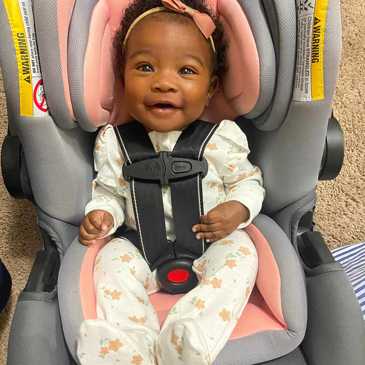 Sarae is registered to the contest to win money with this photo: baby, babylaughing, car, car_interior, carseat, clothing, face, hair, happy, head, person, sitting, sleeve, smile, tape, transportation, vehicle