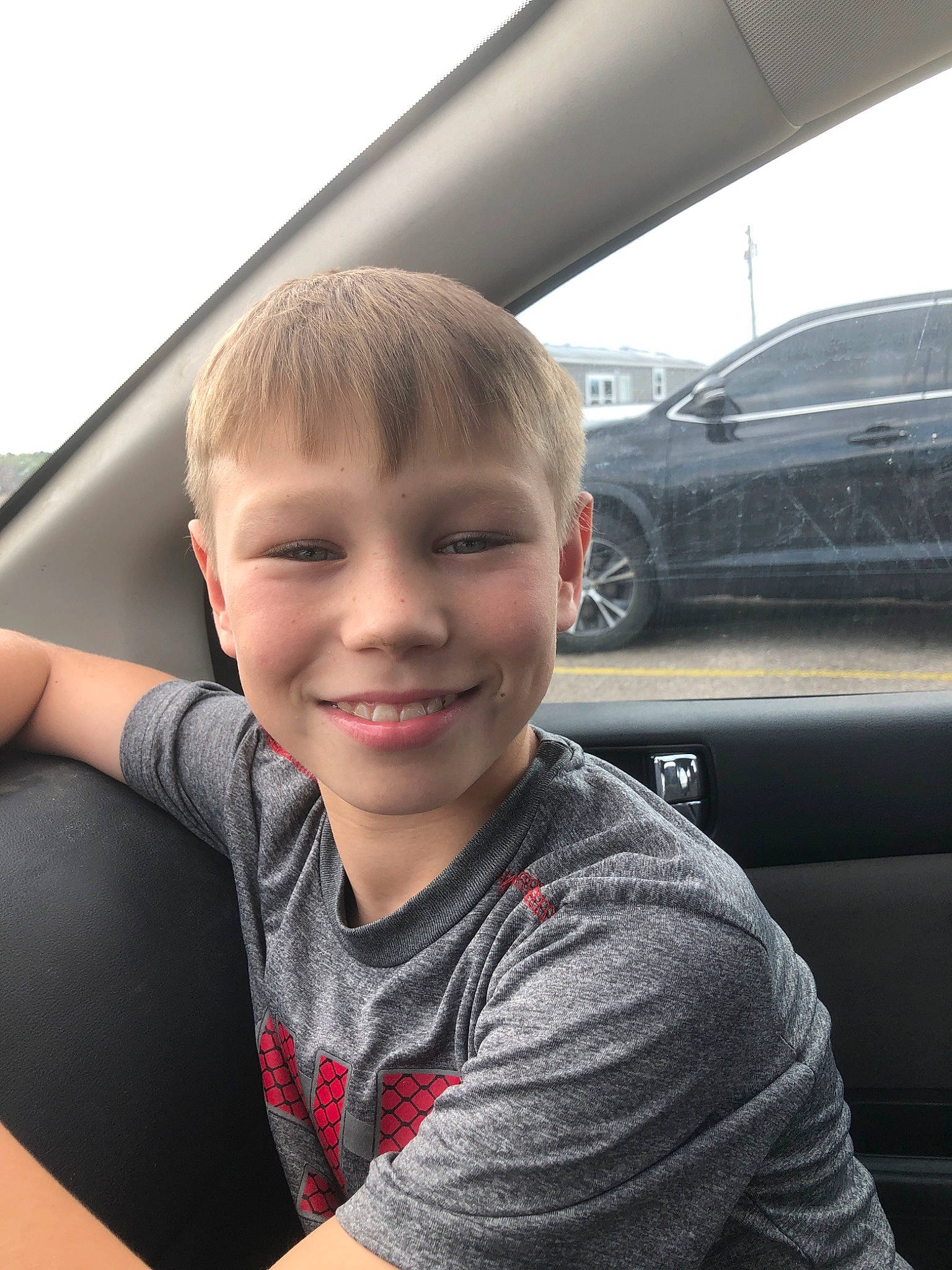 Nik Dixon joined the competition — help win amazing prizes! arm, blond, car, cheek, child, cool, driving, eye, face, facial_expression, hair, hairstyle, hand, head, joy, luxury_vehicle, person, skin, smile, toddler