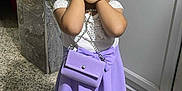 Elena a rejoint le concours — aidez-le/la à gagner de superbes lots ! child, girl, posing, purple_skirt, white_top, purse, marble_wall, floor, sandals, smiling, cute, standing, indoors, fashion, accessories, portrait, person, young, happy, playful