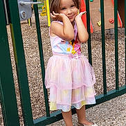 Elena participe au concours pour gagner de l'argent avec cette photo : child, girl, dress, playground, gate, shoes, posing, outdoor, smiling, cute, fence, play_equipment, colorful, happy, young, person, toddler, fashion, portrait, park