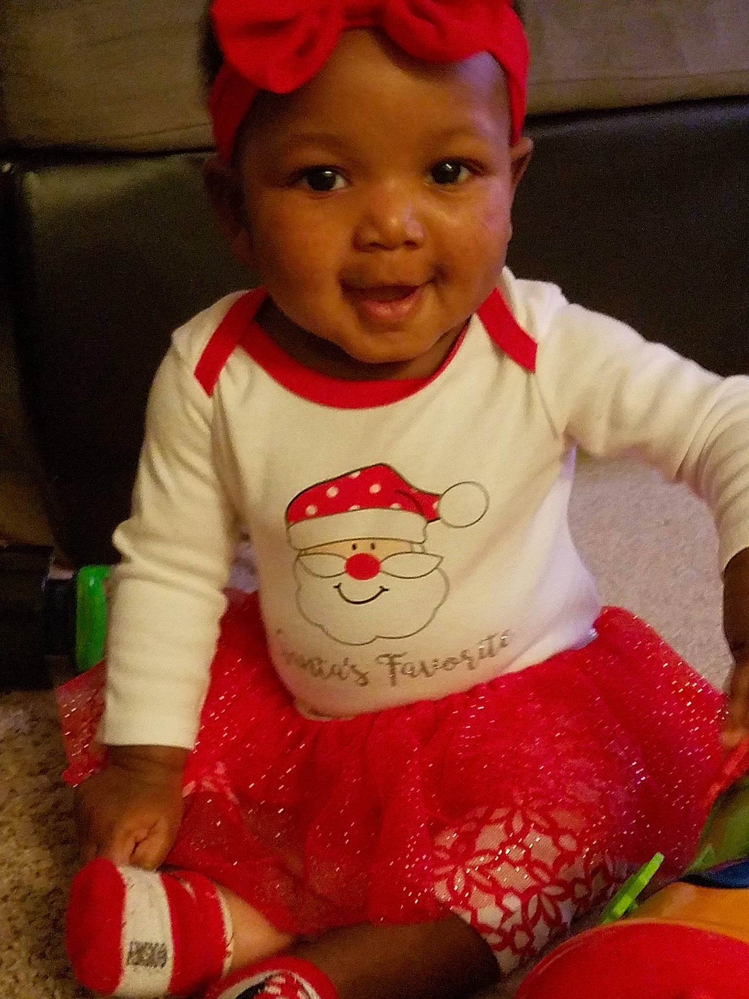 Kelsie is registered to the contest to win money with this photo: baby, baby_toddler_clothing, cheek, child, christmas, headgear, person, play, red, smile, toddler