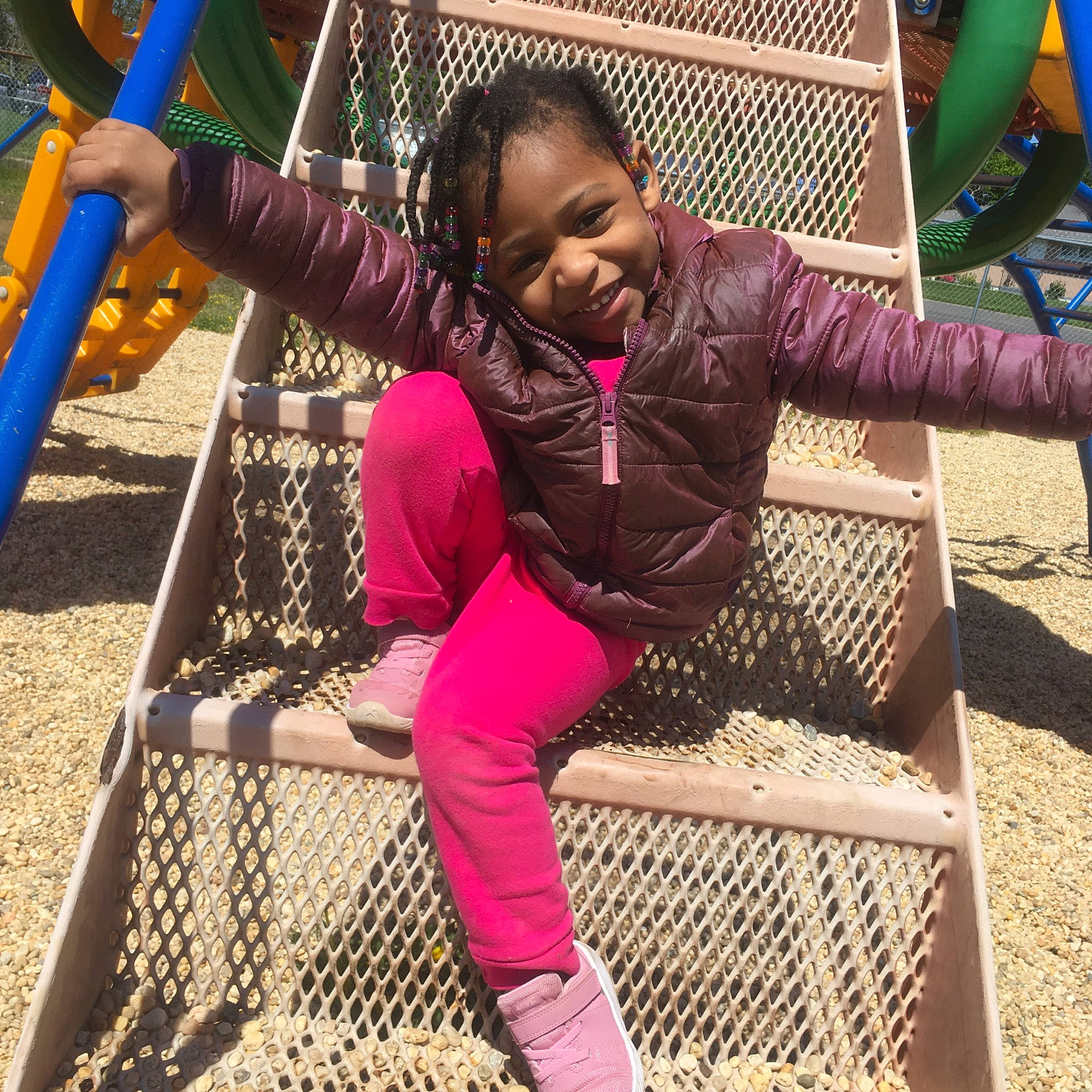 Kiara is registered to the contest to win money with this photo: child, city, fun, human_settlement, joy, leisure, outdoor_play_equipment, person, pink, plant, play, playground, public_space, recreation, smile, swing, toddler, tree, vacation