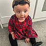 baby, child, girl, plaid_dress, black_tights, black_shoes, headband, bow, carpet, floor, indoor, cute, sitting, portrait, person, clothing, fashion, expression, young, smiling