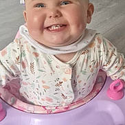 Olivia is registered to the contest to win money with this photo: baby, smiling, child, baby_walker, toys, indoor, onesie, face, happy, floor, butterfly_toy, pink, purple, person, infant, cheeks, clothing, room, doorway, joyful