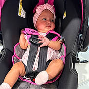 Catalina joined the competition — help win amazing prizes! baby, baby_girl, car_seat, child, clothing, curious_expression, cute, ears, face, headwear, indoor, infant, mickey_mouse_pattern, person, pink_headband, safety, seatbelt, sitting, socks, straps