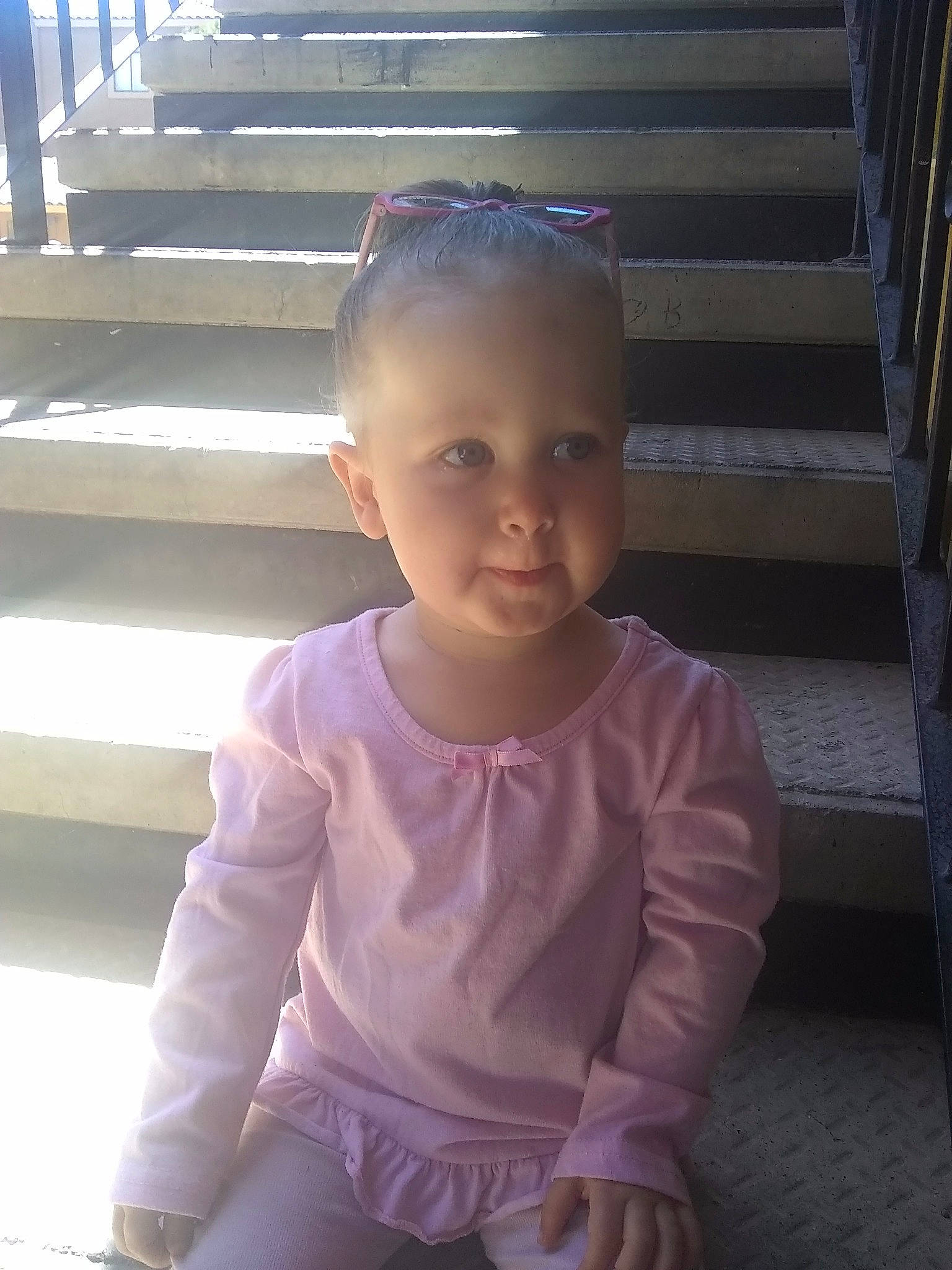 Myra is registered to the contest to win money with this photo: cheek, child, face, head, person, pink, sitting, skin, smile, standing, toddler