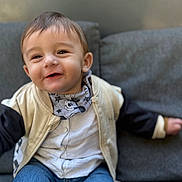 Kristiyan joined the competition — help win amazing prizes! toddler, child, smiling, jacket, scarf, jeans, couch, indoor, face, happy, person, clothing, portrait, sitting, baby, casual_wear, cute, young_child, fashion, cozy