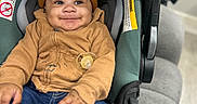 Malyk joined the competition — help win amazing prizes! baby, child, car_seat, beanie, hoodie, pacifier, smile, happy, indoor, jeans, clothing, infant, cute, person, seatbelt, sitting, portrait, cozy, warm_clothing, headwear