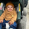 baby, child, car_seat, beanie, hoodie, pacifier, smile, happy, indoor, jeans, clothing, infant, cute, person, seatbelt, sitting, portrait, cozy, warm_clothing, headwear