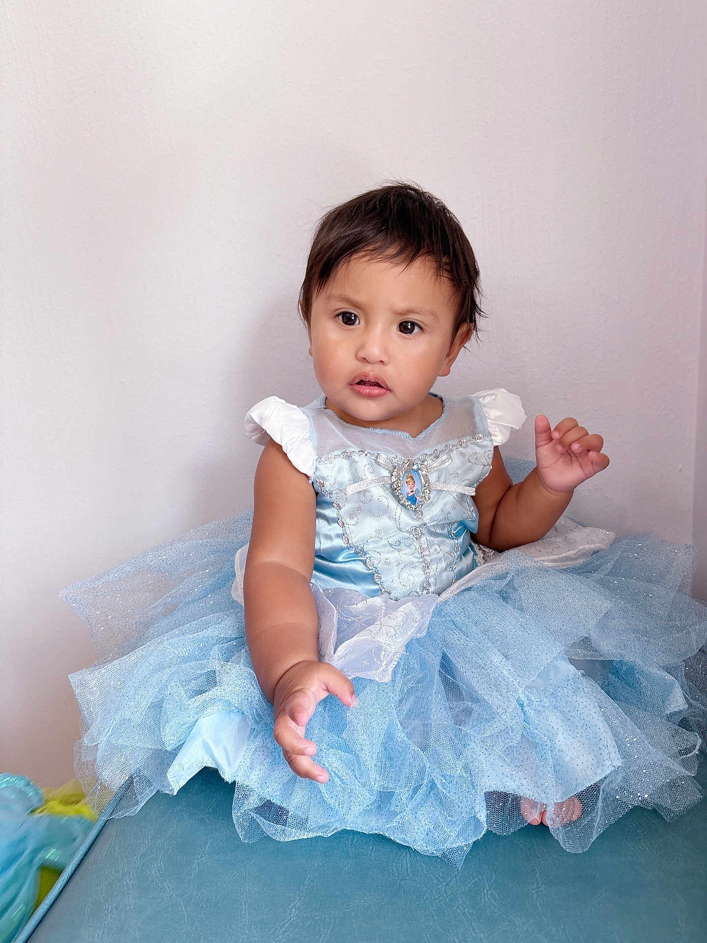 Jimena joined the competition — help win amazing prizes! child, toddler, baby, princess_dress, blue_dress, tulle, sitting, portrait, indoor, white_wall, short_hair, brown_eyes, cute, hand, bare_feet, sparkle, fabric, glitter, photography, expression