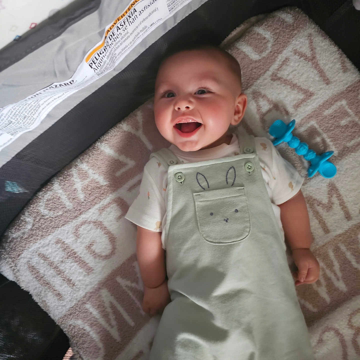 Haloo joined the competition — help win amazing prizes! baby, smiling, infant, playpen, blanket, toy, overalls, cute, happy, child, lying_down, indoors, soft, clothing, face, person, baby_toy, expression, playtime, comfort