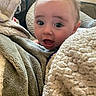 baby, blanket, face, child, cozy, couch, expression, indoor, infant, living_room, person, plush, portrait, soft_texture, surprise, toddler, warm, wide_eyes, young, head