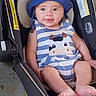 apparel, baby, baby_clothes, blue_hat, car_seat, child, cute, face, footwear_free, happy, headwear, indoors, infant, person, portrait, seat, sitting, smiling, striped_onesie, young_child