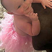 Sterling is registered to the contest to win money with this photo: baby, child, tutu, pink, cute, smiling, indoor, carpet, cushion, skin, cheeks, hand, portrait, infant, happy, funny_pose, closeup, soft, adorable, playful