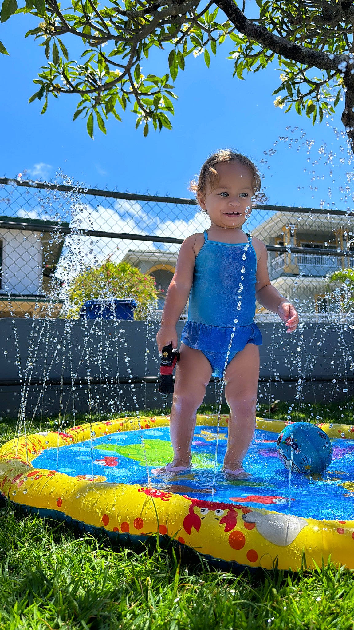 Aaliyah joined the competition — help win amazing prizes! azure, baby_toddler_clothing, child, electric_blue, fun, grass, happy, hat, inflatable, joy, leisure, nature, people_in_nature, person, personal_protective_equipment, play, recreation, sky, swimwear, toddler