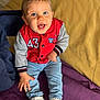 Noé a rejoint le concours — aidez-le/la à gagner de superbes lots ! toddler, child, smiling, blue_eyes, red_jacket, jeans, sneakers, sitting, indoor, blanket, yellow_background, happy, cute, portrait, casual_clothing, young_child, small_hands, face, person, playful