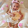 Lunabelle is registered to the contest to win money with this photo: 4_months, adorable, baby, blanket, celebration, child, cute, flower_petals, happy, headband, indoors, infant, knitted_blanket, pink_bow, plaque, portrait, sitting, smiling, soft_lighting, white_dress