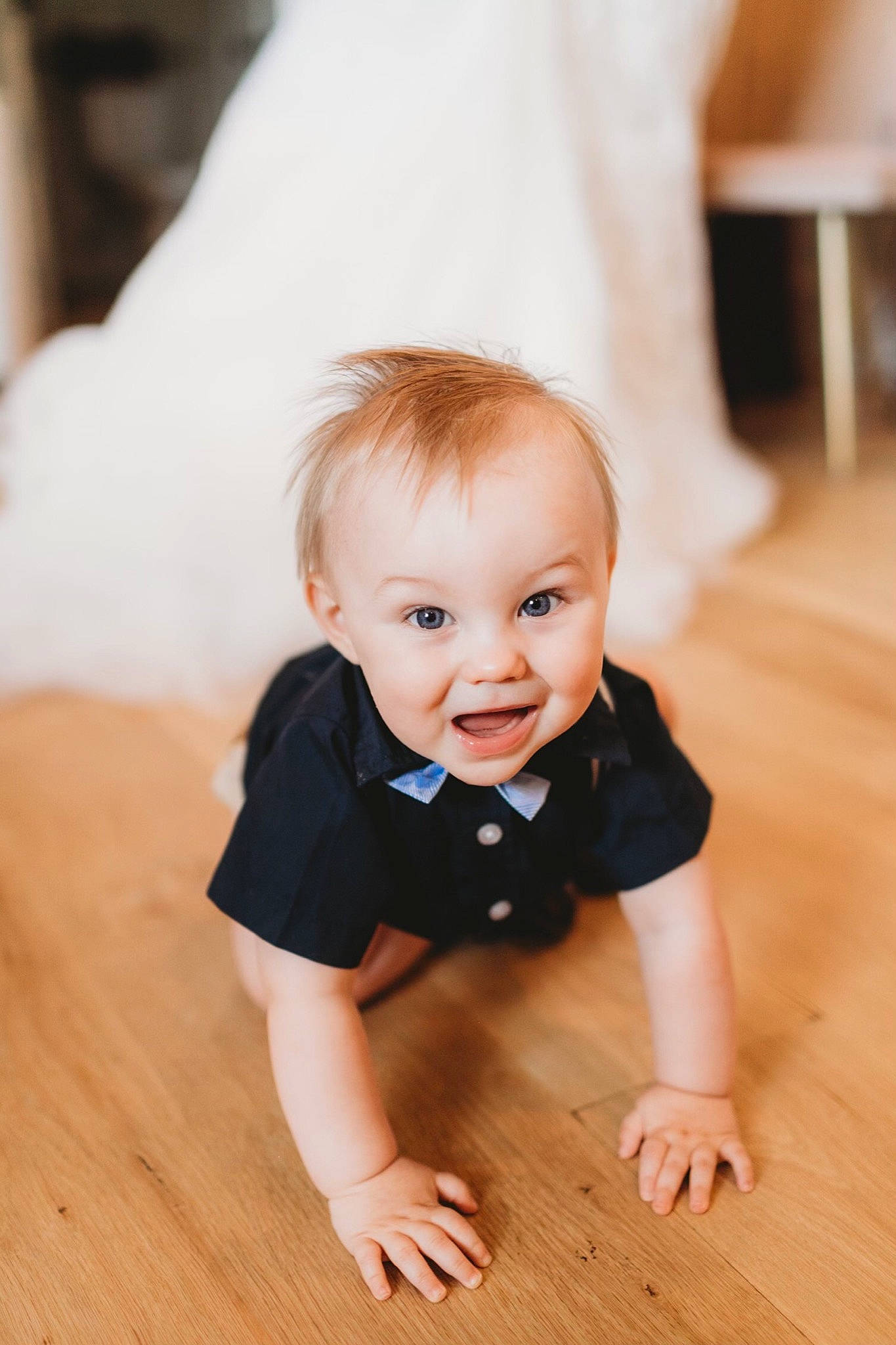 Grayson is registered to the contest to win money with this photo: baby, baby_toddler_clothing, cheek, dress, eye, flash_photography, floor, flooring, grey, happy, hardwood, iris, laminate_flooring, person, skin, sleeve, smile, surprise, toddler, wood