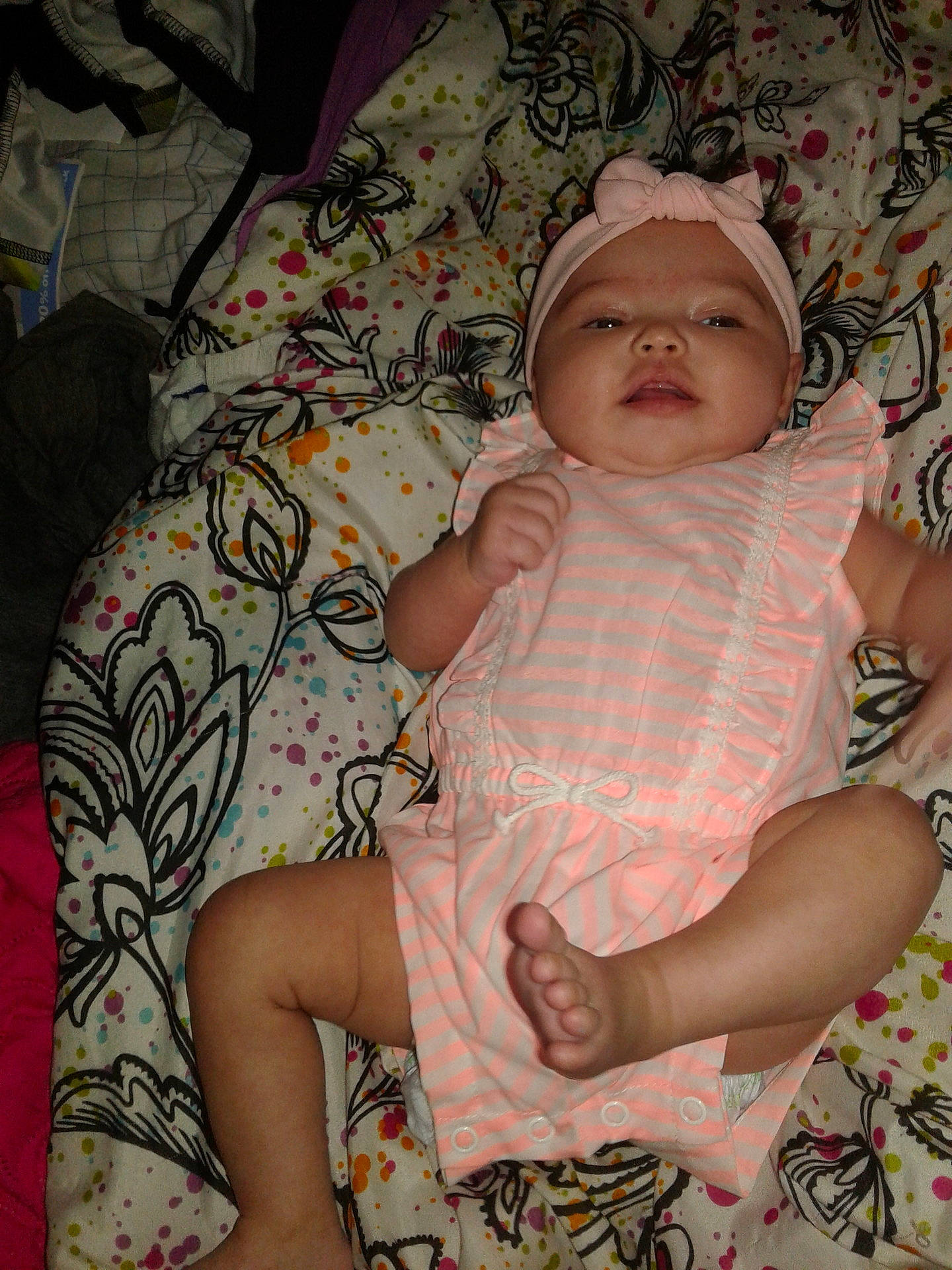 Maizie is registered to the contest to win money with this photo: abdomen, arm, child, design, eye, girl, headwear, infant, pattern, person, pink, product, skin, smile, textile, toddler, trunk