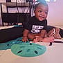 Liam is registered to the contest to win money with this photo: baby, child, indoor, black_shirt, smiling, sitting, floor_mat, computer, chair, furniture, person, happy, home, technology, foot, hand, expression, clothing, baby_toddler, young_child