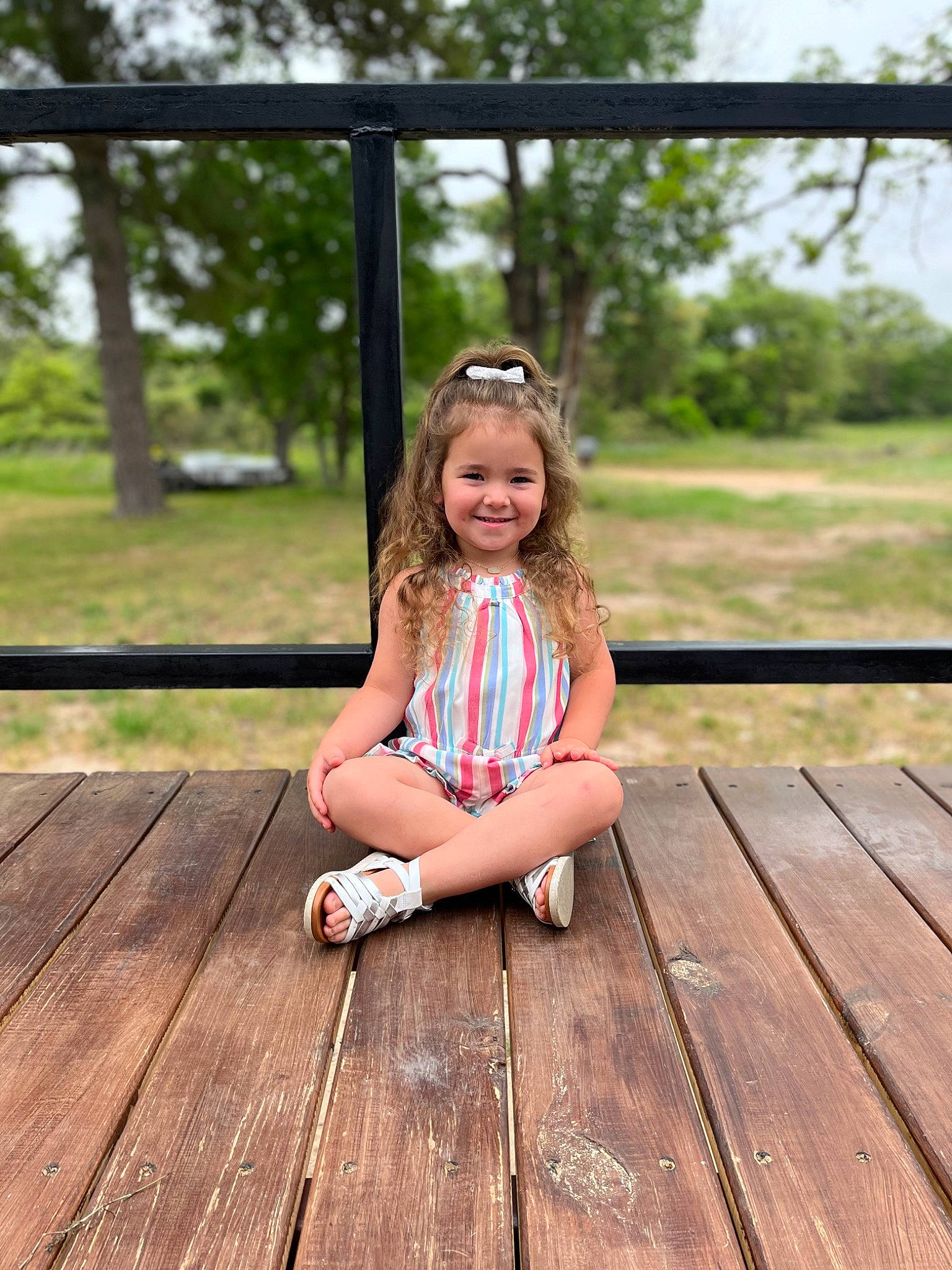 Ivory is registered to the contest to win money with this photo: blond, boardwalk, bridge, child, fun, grass, happy, hardwood, human_leg, joy, leg, leisure, person, plank, plant, recreation, smile, sneakers, toddler, tree