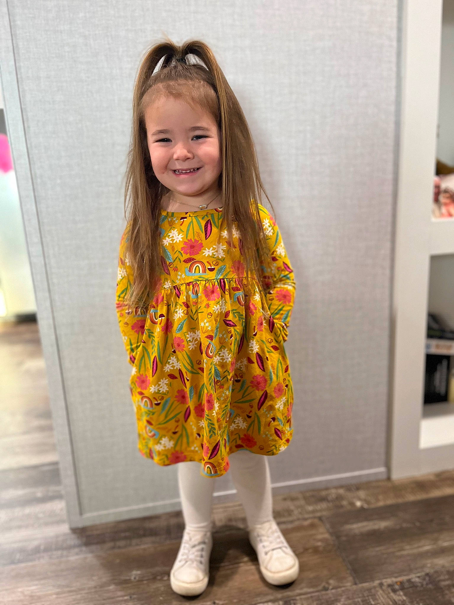 Ivory is registered to the contest to win money with this photo: baby_toddler_clothing, cheek, floor, flooring, hair, happy, iris, joy, knee, mammal, one_piece_garment, pattern, person, pink, shelf, skin, sleeve, smile, standing, street_fashion