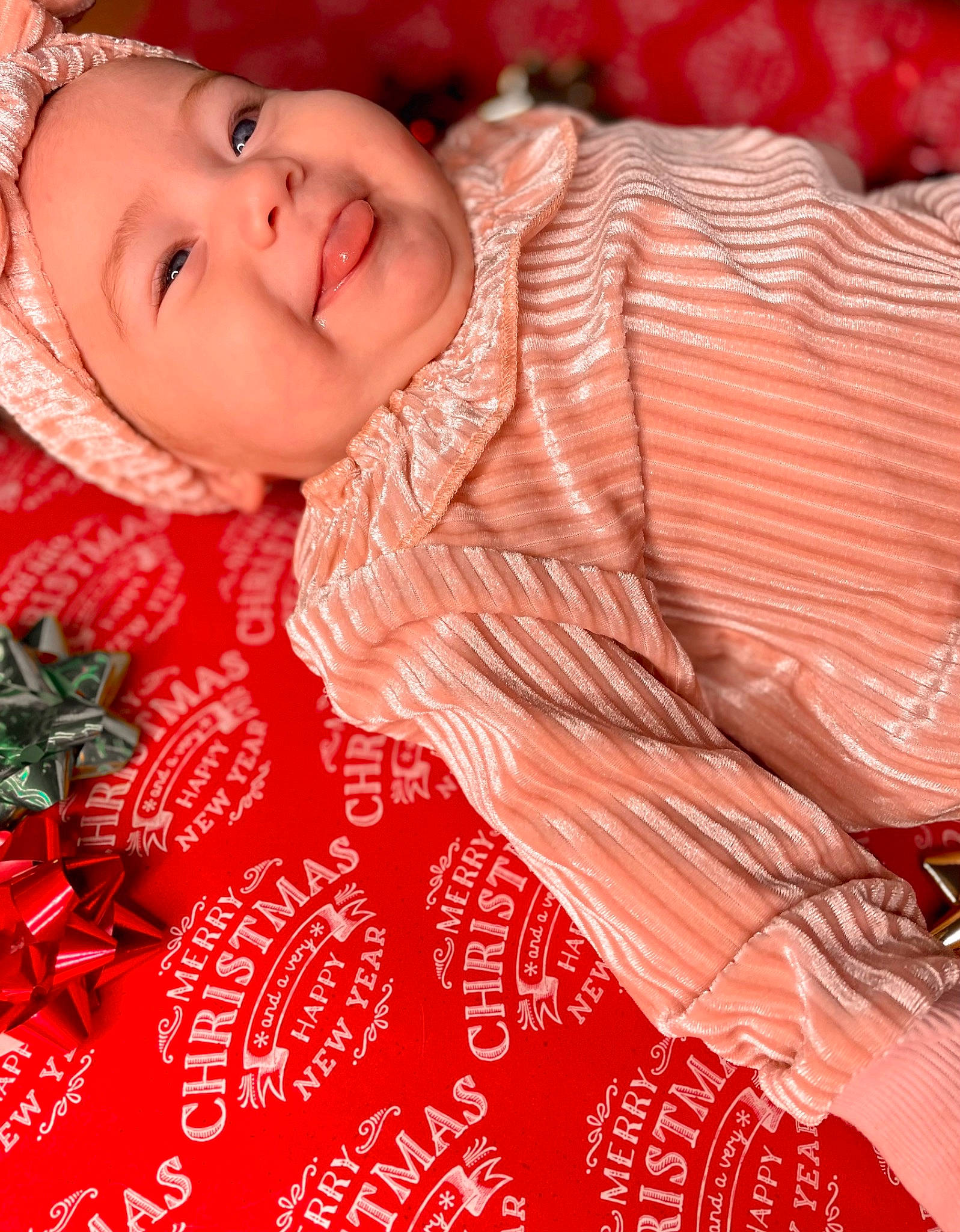 Thea is registered to the contest to win money with this photo: baby, event, face, flesh, font, happy, headwear, joy, laugh, lip, magenta, pattern, peach, people_in_nature, person, petal, pink, plant, portrait_photography, red