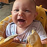 baby, smiling, infant, yellow, giraffe, seat, happy, child, cute, indoors, face, clothing, young, joyful, portrait, drool, comfort, cozy, bright, expression