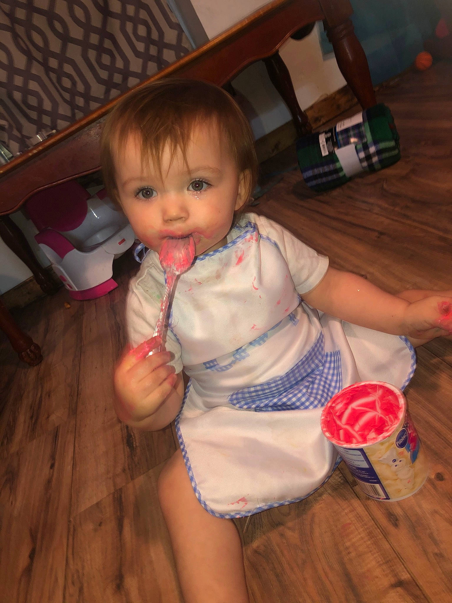 Leslie is registered to the contest to win money with this photo: arm, baby, cheek, child, eye, finger, floor, flooring, fun, iris, leg, person, play, sitting, skin, smile, standing, thumb, toddler, trunk