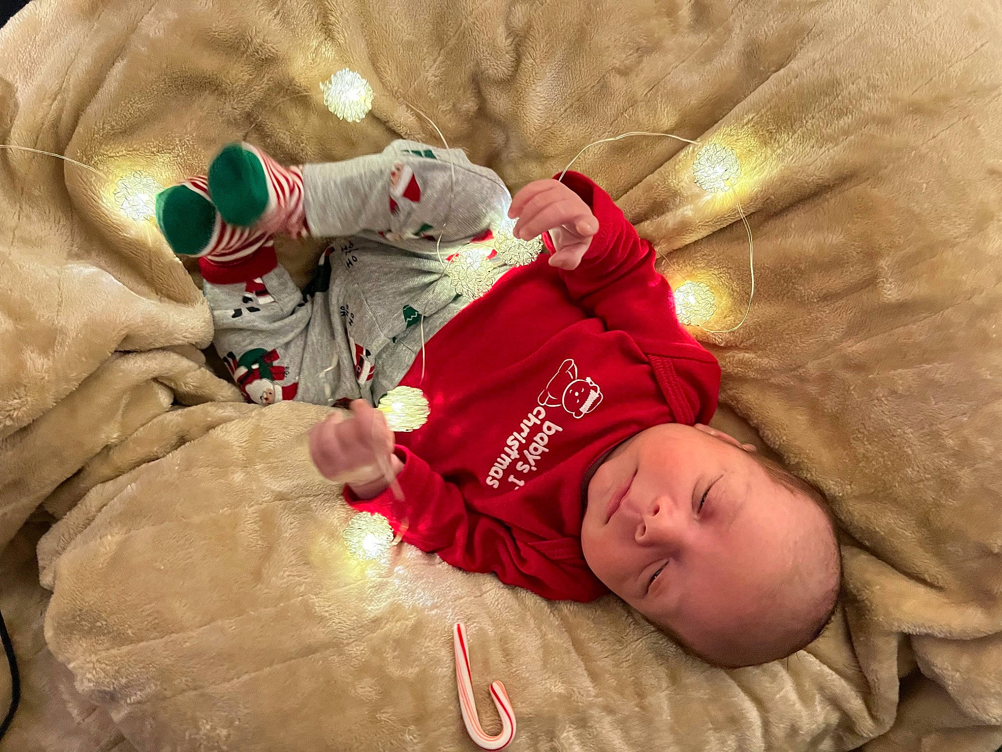 Jackson is registered to the contest to win money with this photo: baby, child, christmas, christmas_eve, comfort, event, face, foot, fun, fur, happy, hat, holiday, lap, linens, person, room, sitting, sleeve, t_shirt