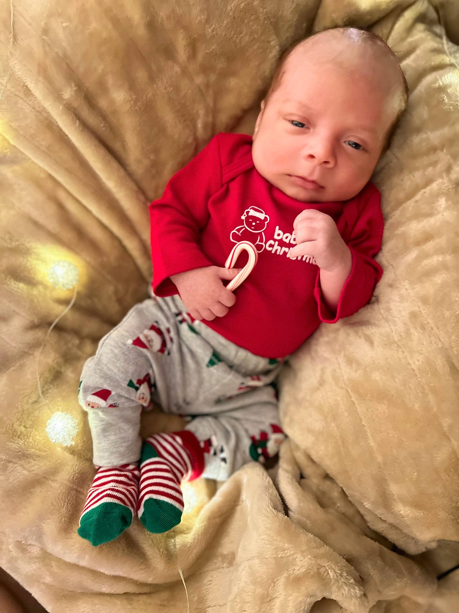 Jackson is registered to the contest to win money with this photo: baby, baby_toddler_clothing, child, christmas, comfort, face, finger, happy, head, leg, linens, mammal, outerwear, person, skin, sleeve, smile, sock, textile, toddler
