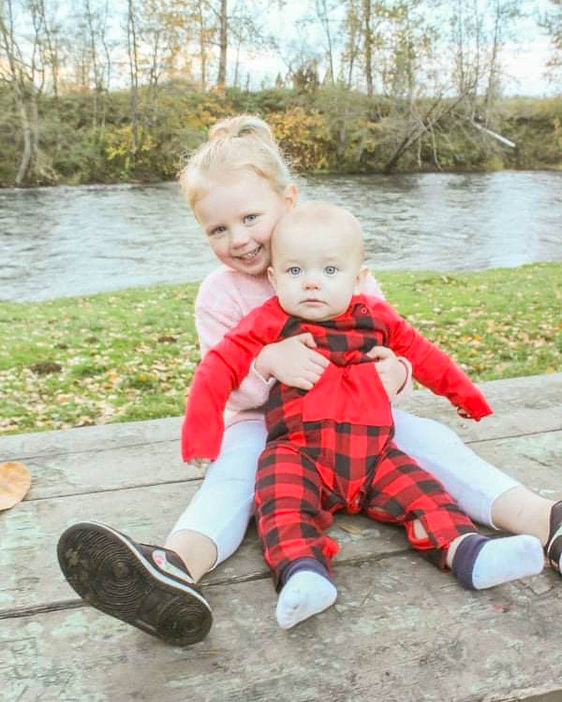 Hunter is registered to the contest to win money with this photo: baby, baby_toddler_clothing, doll, fun, grass, happy, joy, lake, leaf, people_in_nature, person, plant, shoe, sky, smile, sneakers, t_shirt, tartan, toddler, toy