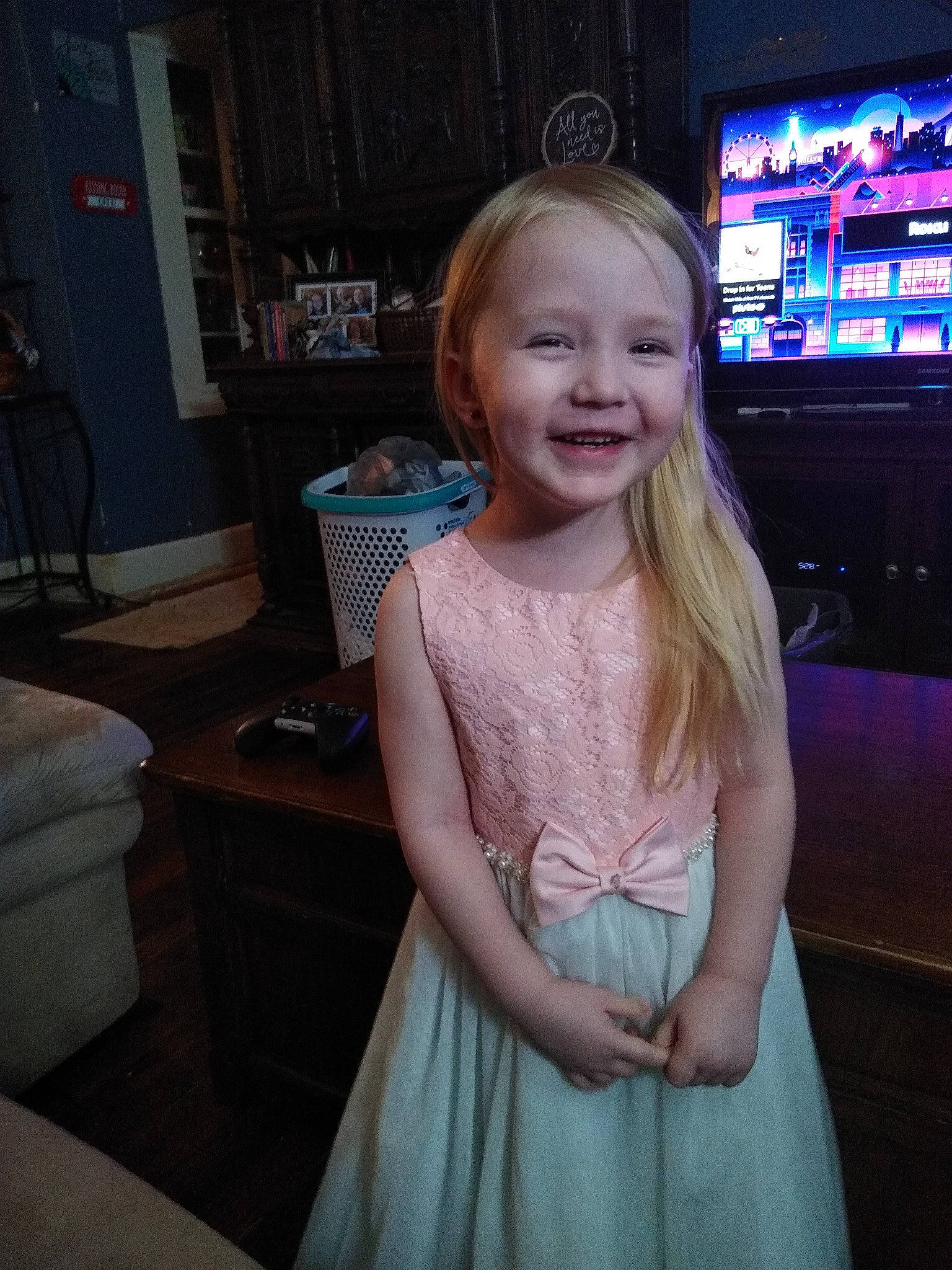 Felicity is registered to the contest to win money with this photo: arm, child, day_dress, dress, event, face, facial_expression, flash_photography, flooring, hair, hairstyle, happy, human_body, iris, joy, long_hair, person, shoulder, smile, television