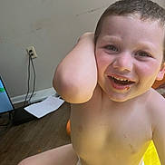 Hunter is registered to the contest to win money with this photo: child, boy, diaper, smiling, indoor, yellow, floor, happy, cute, face, skin, arm, leg, light, casual, childhood, portrait, sitting, playful, young