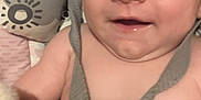 Eric joined the competition — help win amazing prizes! baby, smiling, blue_eyes, harness, close_up, infant, child, blanket, pattern, soft_skin, hand, face, cute, young, indoors, happy, person, portrait, baby_clothing, lying_down