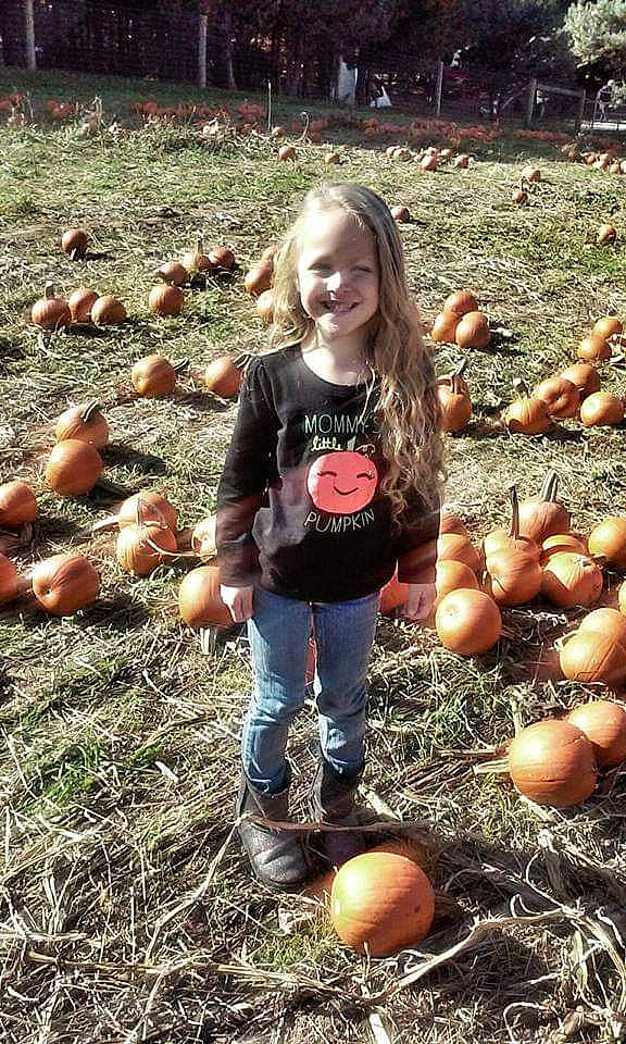 Serenity is registered to the contest to win money with this photo: adaptation, agriculture, calabaza, cucurbita, food, gourd, grass, happy, joy, leg, local_food, natural_foods, people, people_in_nature, person, photograph, plant, pumpkin, smile, squash