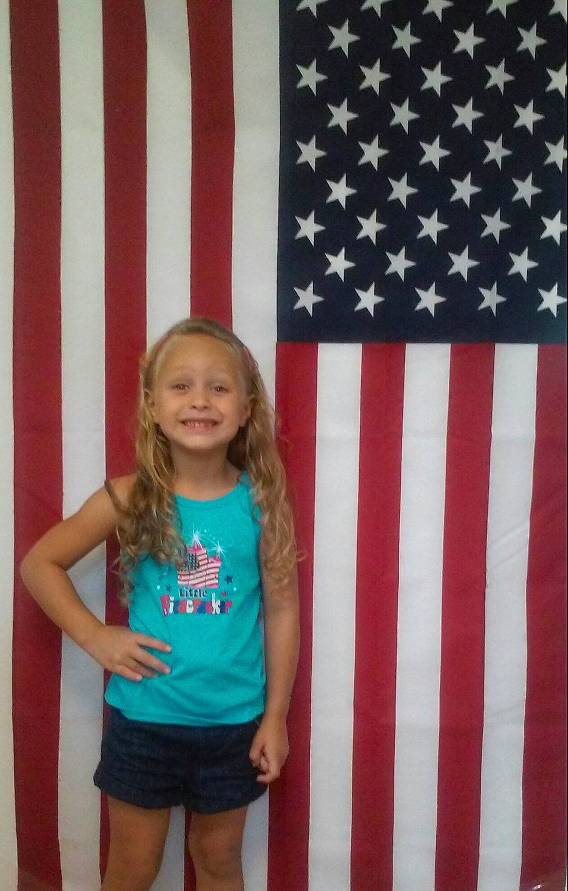 Serenity is registered to the contest to win money with this photo: child, flag, flag_of_the_united_states, joy, pattern, person, room, t_shirt, textile, toddler, vacation