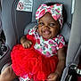 Eloni joined the competition — help win amazing prizes! baby, child, car_seat, smiling, headband, bow, red_skirt, tutu, strawberry_pattern, cute, happy, infant, clothing, sitting, portrait, indoors, seatbelt, safety, person, young_child