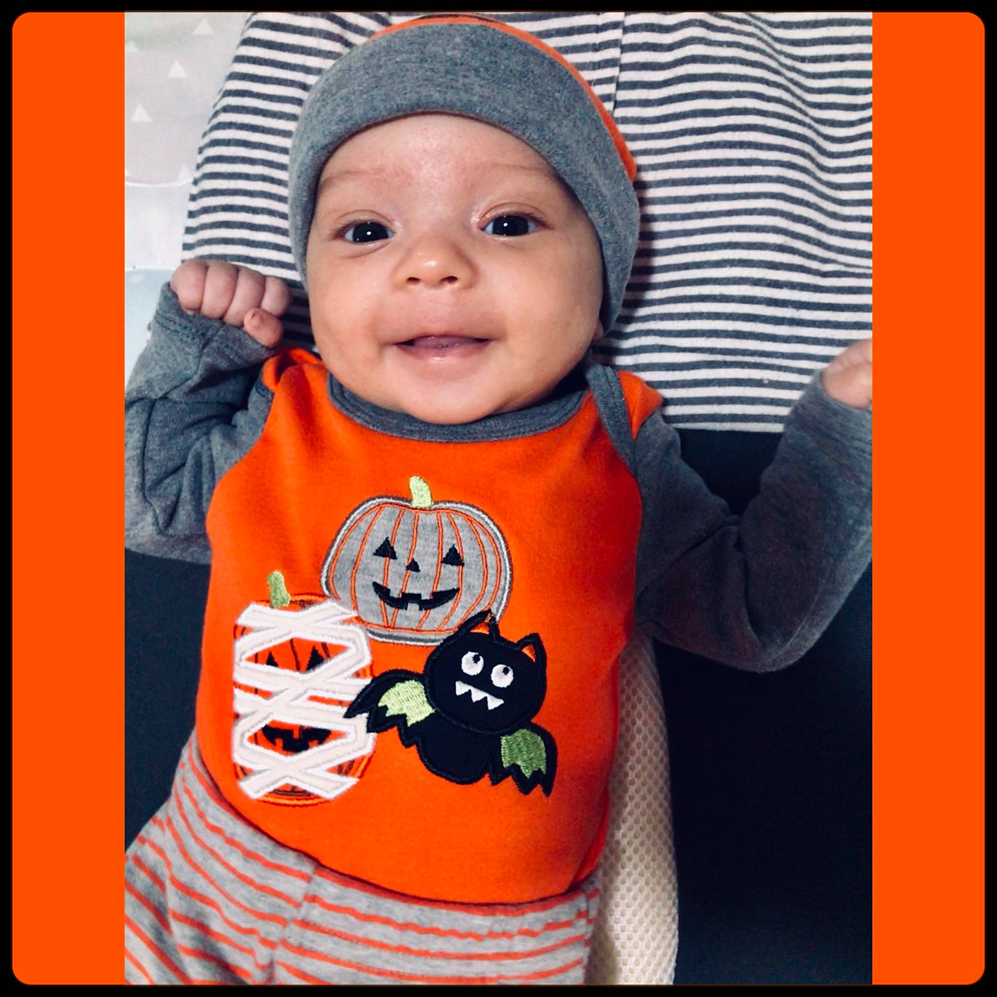 Julio is registered to the contest to win money with this photo: baby, baby_products, baby_toddler_clothing, cheek, child, cool, facial_expression, head, headwear, orange, outerwear, person, product, sleeve, smile, t_shirt, toddler