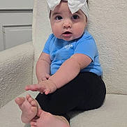 Harlyn joined the competition — help win amazing prizes! baby, child, infant, bow, headband, blue_shirt, black_pants, bare_feet, sitting, portrait, indoors, chair, cushion, wall, door, wide_eyed, curious, cute, fashion, foot
