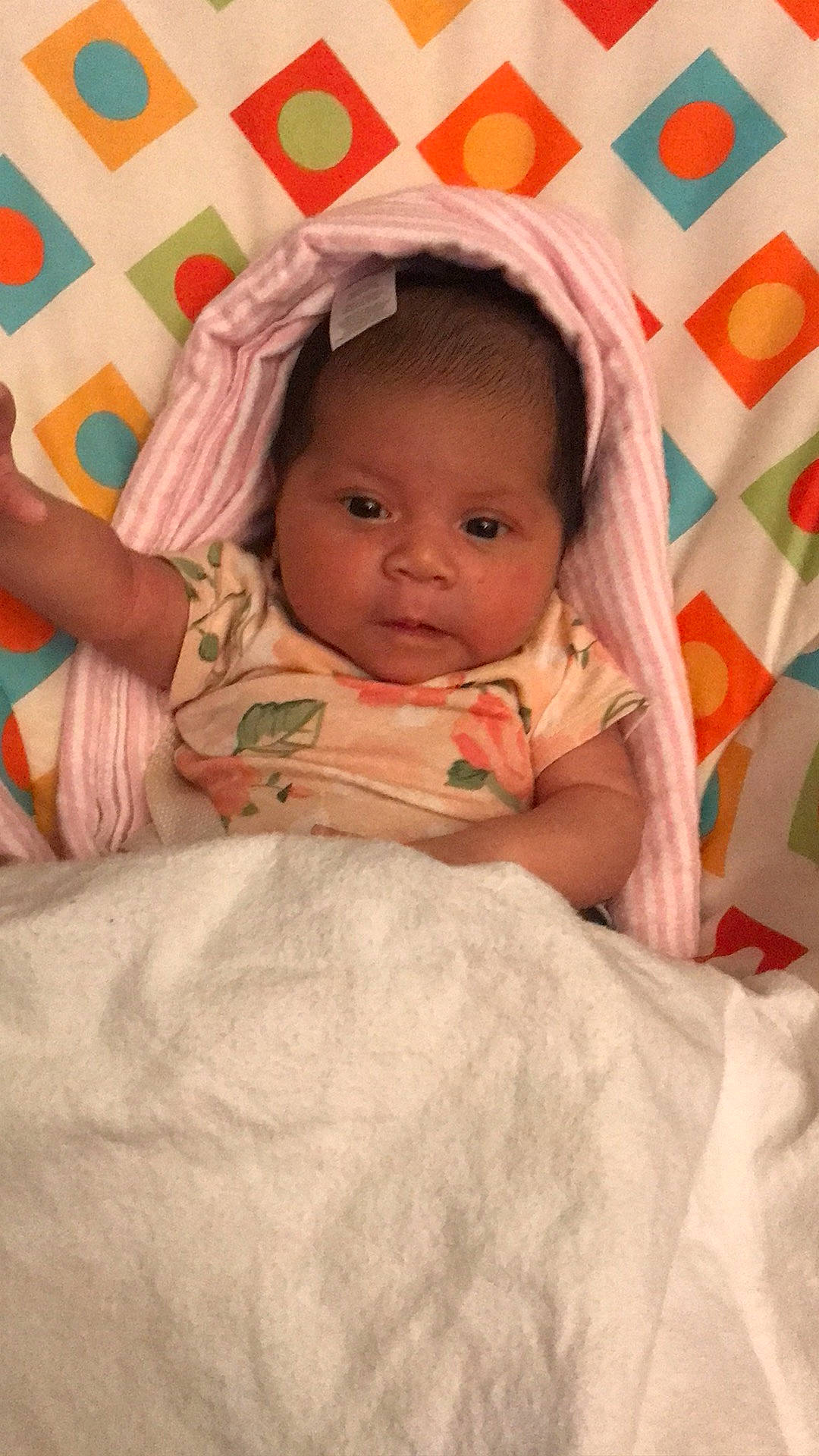 Kyla is registered to the contest to win money with this photo: arm, baby, baby_toddler_clothing, cheek, chin, comfort, eye, eyebrow, face, finger, hand, human_body, iris, lip, mouth, nose, person, pink, skin, sleeve