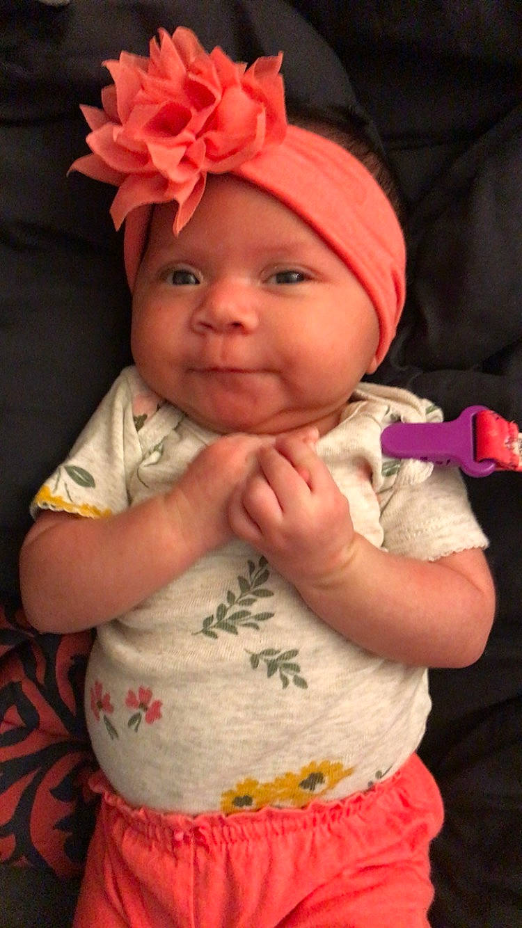 Kyla joined the competition — help win amazing prizes! baby_toddler_clothing, cap, cheek, chin, dress, face, finger, happy, head, headgear, headwear, human_body, lip, mouth, nose, person, pink, plant, skin, sleeve
