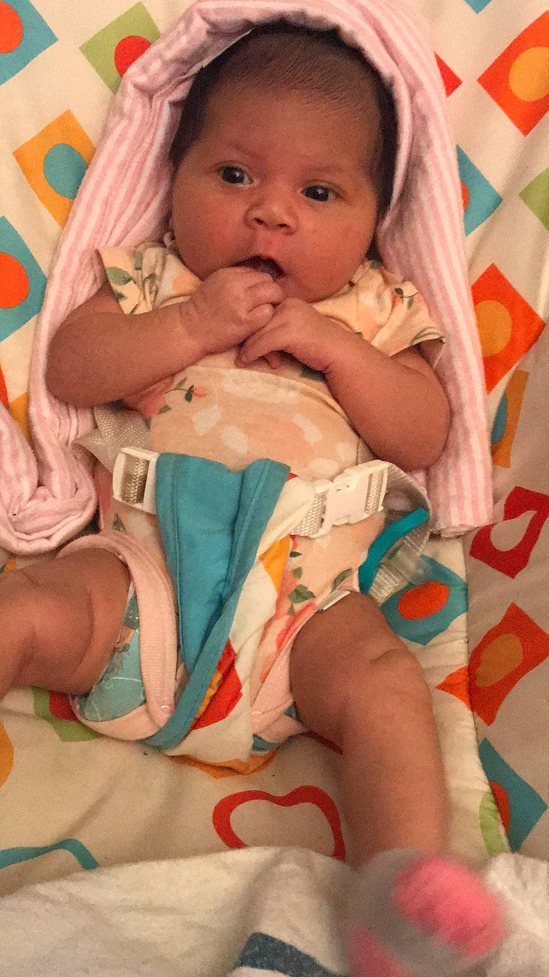 Kyla is registered to the contest to win money with this photo: abdomen, baby, baby_toddler_clothing, cheek, child, comfort, eye, eyelash, face, finger, head, linens, mouth, nail, person, pink, skin, textile, thigh, toddler