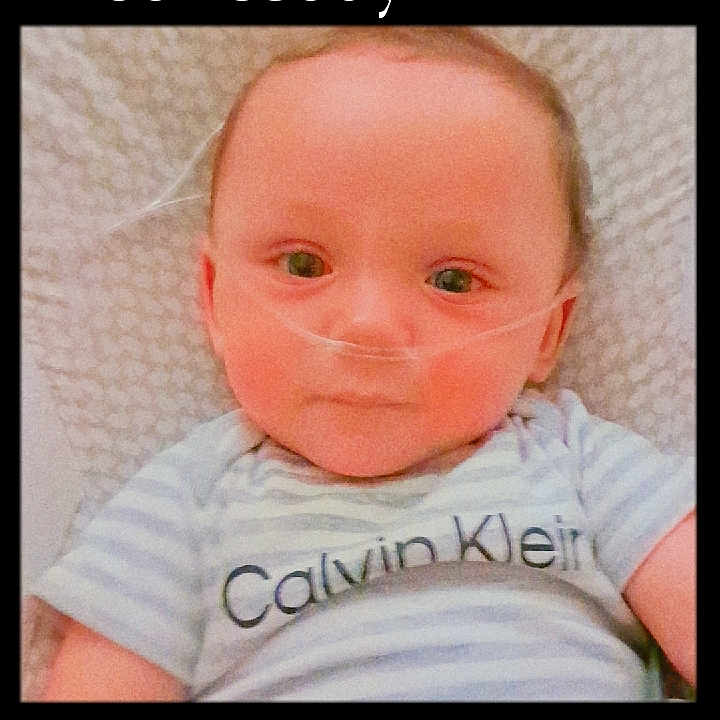 Justice joined the competition — help win amazing prizes! baby, infant, nasal_cannula, striped_shirt, calvin_klein, blanket, closeup, face, portrait, lying_down, child, medical_device, cute, indoors, young, person, head, expression, eyes, soft_lighting