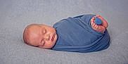 Edwin is registered to the contest to win money with this photo: baby, newborn, sleeping, wrapped, blue_blanket, feet, heart, soft_texture, peaceful, infant, portrait, closeup, cute, child, resting, toddler, indoors, cozy, blanket_wrap, baby_feet