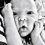 Edwin is registered to the contest to win money with this photo: baby, infant, close_up, black_and_white, face, arms, expression, puckered_lips, wide_eyes, skin, newborn, cute, star_pattern, clothing, portrait, child, hands, resting, adorable, monochrome