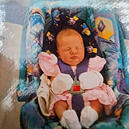 Edwin is registered to the contest to win money with this photo: baby, baby_accessory, car_seat, child, childcare, colorful, cute, fabric, indoor, infant, newborn, pink_clothing, portrait, resting, seatbelt, sleeping, small, soft_focus, toddler, white_mittens