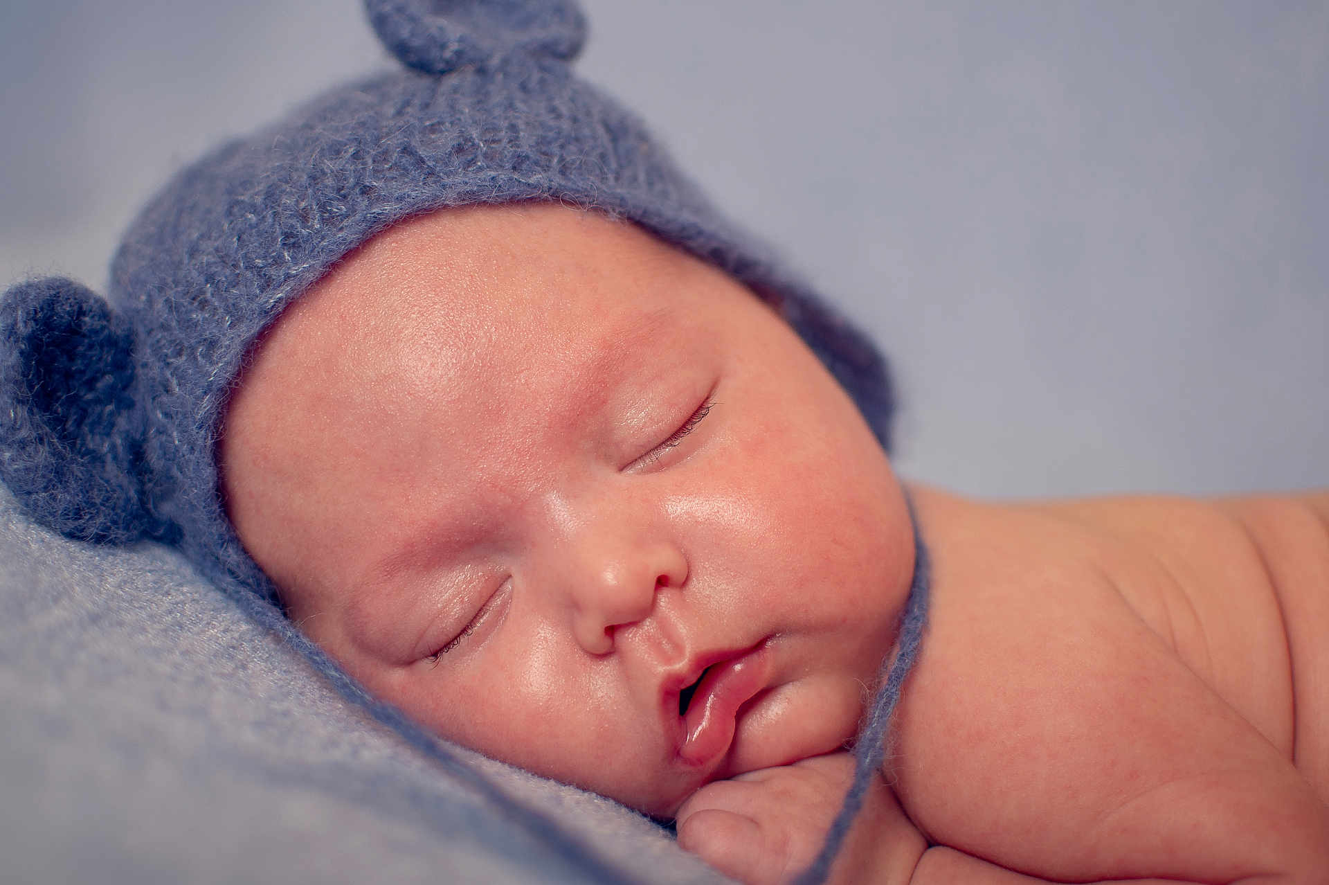 Edwin is registered to the contest to win money with this photo: baby, infant, sleeping, hat, knit_hat, blue, soft_texture, closeup, face, cheeks, skin, peaceful, cute, newborn, resting, portrait, child, warm, cozy, blanket