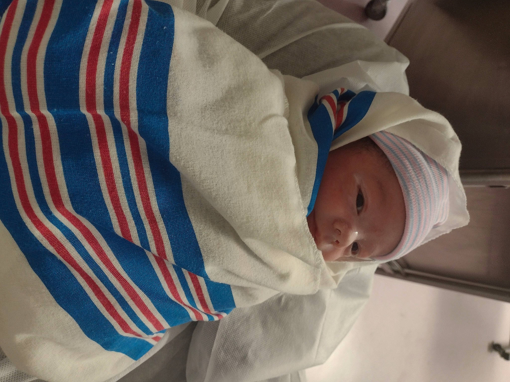 Calvin is registered to the contest to win money with this photo: baby, baby_products, baby_safety, baby_toddler_clothing, carmine, child, comfort, electric_blue, event, flag_of_the_united_states, hat, headwear, linens, person, sleeve, smile, toddler